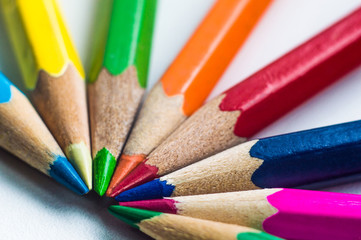 Pencils in different colors on white background