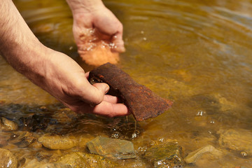Man found rusty iron metal axe in river water by magnet