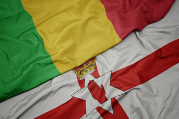 waving colorful flag of northern ireland and national flag of mali.