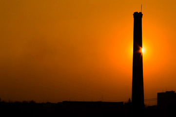 Sunset  behind the tower in orange colors