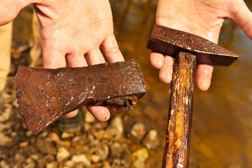 Man found rusty iron metal hammer and axe in river water by magnet
