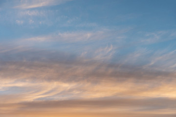 Naklejka na ściany i meble white flat and long clouds at sunset