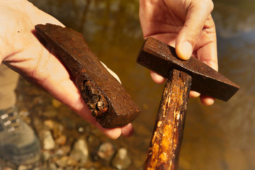 Man found rusty iron metal hammer and axe in river water by magnet
