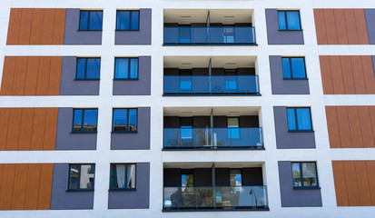 Warsaw, Poland - April 27, 2020: modern apartment buildings in the city. Front view of a modern residential building with balconies and windows.
