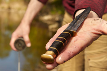 Man found hunting knife in river water by magnet