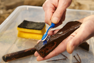 Cleaning of metal axe and hammer found by man with magnet