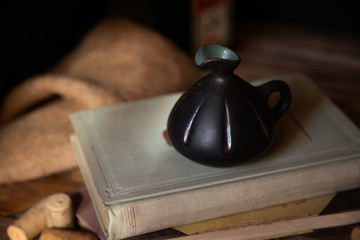 Composition with old vintage books and a jug decorated in vintage style. Books stacking.  Education...