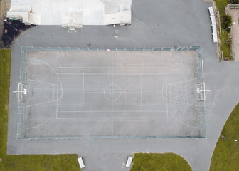 An empty basket ball court on a hot summers day, empty due to the coronavirus lockdown during the corona virus covid 19 epidemic pandemic. Empty public spaces and enforced by the government.