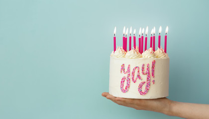 Hand holding birthday cake