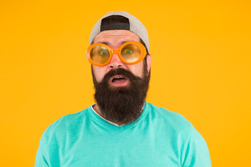 real surprise. freaky man with beard and moustache. man in funny glasses on yellow background. just...