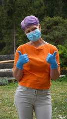 Happy woman in medical face mask with ok gesture. Woman in safety mask and medical gloves. Virus protection, health and hygiene concept