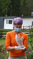 Woman in protective face mask and medical gloves. Health care, COVID-19