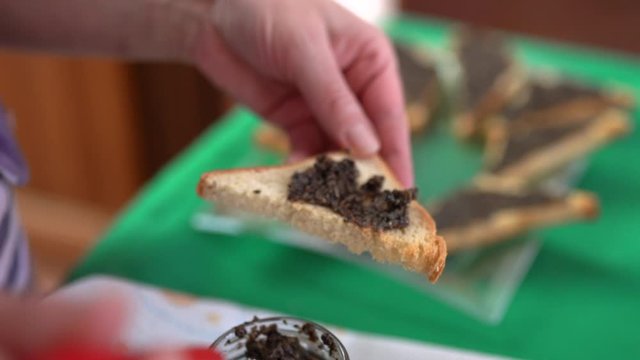 Close-up of classic italian bruschetta with fresh black truffles sauce for banquet. Exclusive truffle mushrooms cream, delicious appetizer served on table. Concept of gourmet cuisine and rare truffles