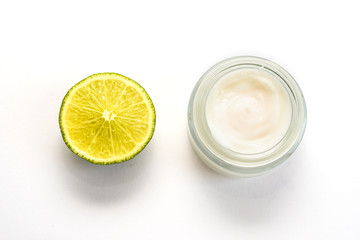 Facial cream and part of lime isolated on the white background.