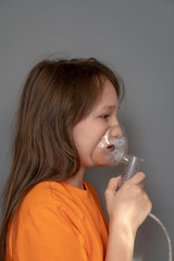 Teenager girl with an inhaler in her hands. Allergy and bronchitis