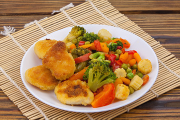 Frozen vegetables gorse or tomatoes corn peas bell peppers carrots on plate
