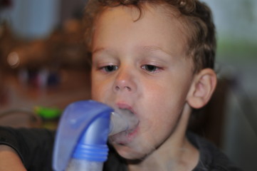 Child inhales with water vapor inhaler