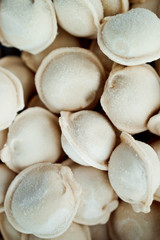 frozen dumplings. dumplings with meat, a lot of freshly frozen dumplings with grains of frost. culinary products made of dough with meat filling