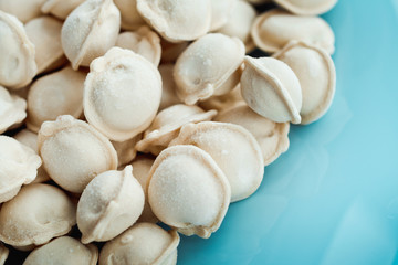 frozen dumplings. dumplings with meat, a lot of freshly frozen dumplings with grains of frost. culinary products made of dough with meat filling