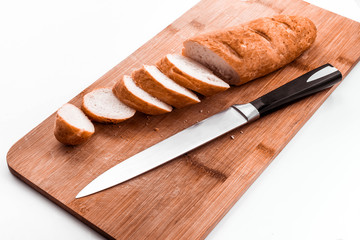 cut the baguette on a wooden Board with a kitchen knife