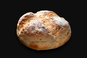 Round bread. Wheat bread isolated on a black background.