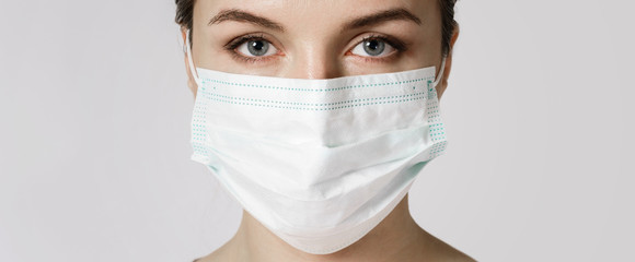 Young woman is wearing a face mask for protection against virus