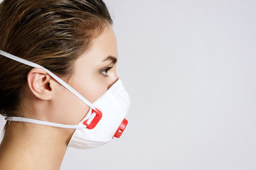 Young woman is wearing a face mask for protection against virus