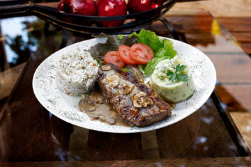 Beef steak with potatoes and rice in isolated white background