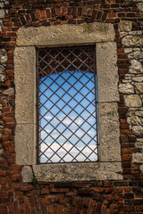 A Window in an ancient wallwith blue sky seen thorough it