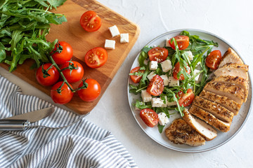 Close-up on a salad with chicken and tomato