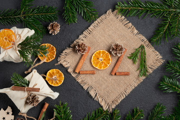 Fototapeta na wymiar Christmas celebration with zero waste concept. Christmas eco-friendly decorations and numbers 2021 from natural materials on a black table
