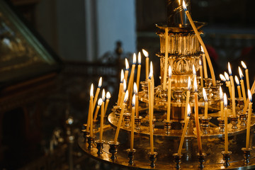 many tapers burn on a church candlestick
