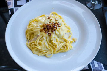 spaghetti carbonara served in a lake side restaurant in lake como, italy