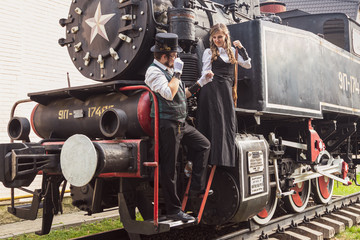 Beautiful girl with a guy, couple in love, in steampunk clothes