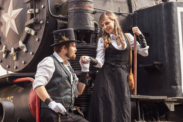 Fototapeta na wymiar Beautiful girl with a guy, couple in love, in steampunk clothes