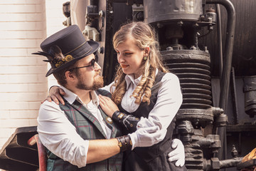 Beautiful girl with a guy, couple in love, in steampunk clothes
