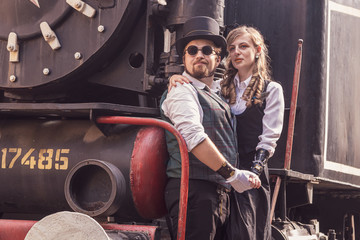Beautiful girl with a guy, couple in love, in steampunk clothes