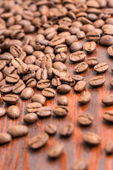 roasted coffee beans close up on wood