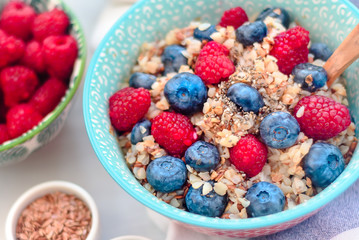 breakfast buckwheat porridge with raspberries and blueberries, good morning concept