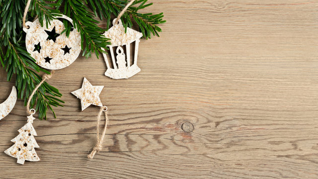 Hand made christmas decorations and christmas tree branches on a wooden table. Template for design in eco style, copy space