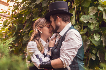 Beautiful girl with a guy, couple in love, in steampunk clothes