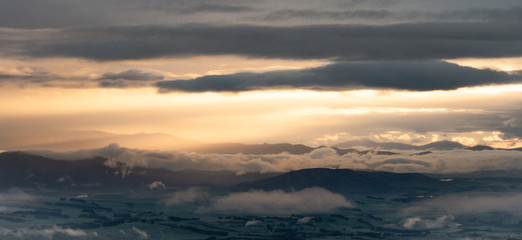 Fototapeta na wymiar Panoramic view on sunrise over the green valley. shot on Kepler Track, Fiordland National Park, New Zealand