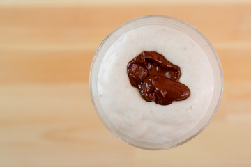 Top view of ice cream smoothie with banana and chocolate.