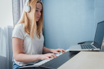 Coronavirus. Quarantine. Online piano music learning with a laptop, education and remote work....