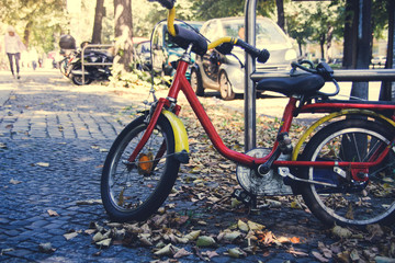 Fototapeta na wymiar Little boy bicycle on a city street in autumn