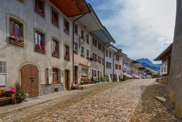 Street in Gruyere village in Fribourg canton by beautiful day, Switzerland
