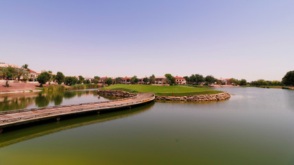 Fototapeta premium beautiful golf course surround with lake in a sunny day.
