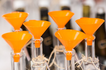 Line of transparent bottles prepared for liquid filling.