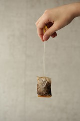 a tea bag in a man's hand
