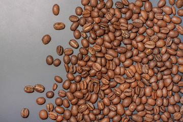 Diagonal composition of coffee beans in the right side with a rough line on isolated dark background